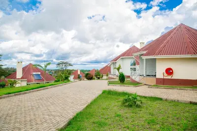 a house with a red roof and a driveway at A1 Hotel and Resort in Arusha