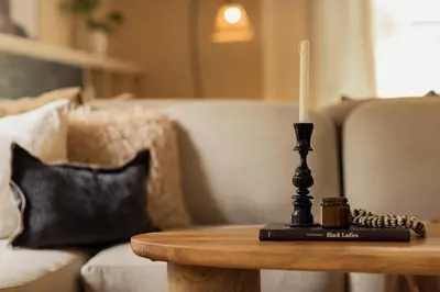 a candle on a coffee table in a living room at Tulia Retreat Hotel and Spa in Arusha