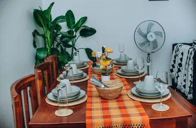 a dining room table with a checkered table cloth at Royal Homestay in Arusha