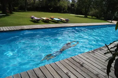 a man swimming in a swimming pool at Meru House Lekisilai in Arusha