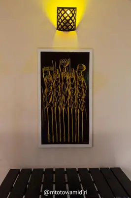 a painting of skeletons on a wall with a light at The House of Black and White in Arusha