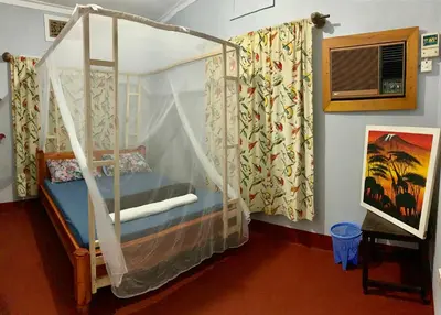 a bedroom with a bunk bed with a canopy at Pazuri Hostel in Moshi