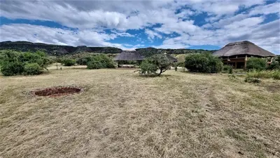 an open field with huts in the middle of a field at Africa Safari Lake Natron Camping in Mtowabaga