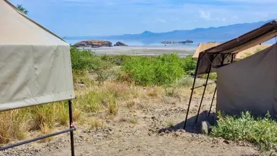 a tent in the desert with a view of the ocean at Africa Safari Lake Natron Camping in Mtowabaga
