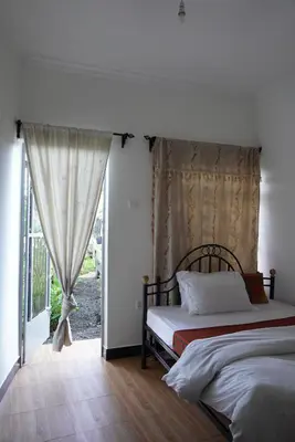 a bedroom with a bed and a window at New Dream House in Arusha