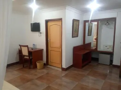 a room with a door and a table and a desk at Karibu Heritage House in Arusha