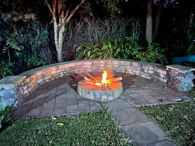a fire pit in a yard with a brick at Karibu Heritage House in Arusha