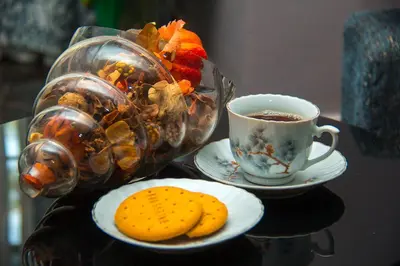 a table with a plate of cookies and a cup of coffee at MINA CHAI HOUSE BNB in Arusha