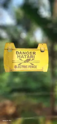 a yellow sign that reads ranger planet electric fence at Kizumba House in Arusha
