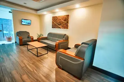 a waiting room at a hospital with couches and a table at seven skies hotel in Arusha