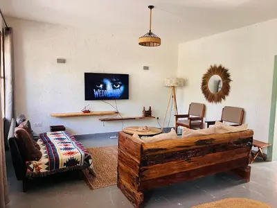 a living room with a couch and a tv at City Retreat Arusha in Arusha
