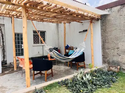 two hammocks hanging under a wooden pergola at City Retreat Arusha in Arusha