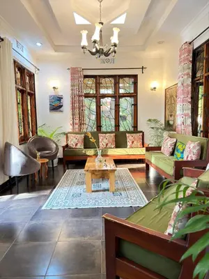 a living room with couches and a table at Sophie Homestay in Moshi