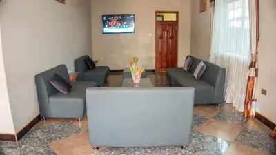a living room with two couches and a table at Elanacha Hotel in Arusha