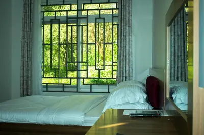 a bedroom with a bed and a large window at Mkomazi Hotels and Camps in Hegoma