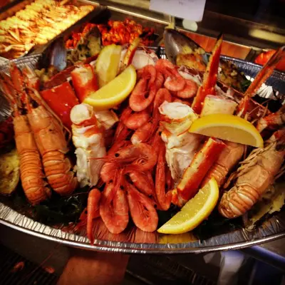 a platter of shrimp and other seafood on a plate at Mkomazi Hotels and Camps in Hegoma