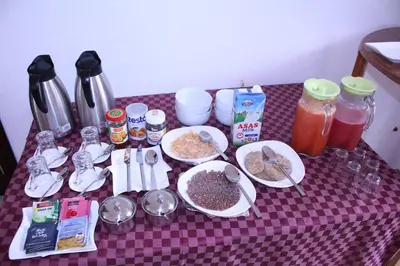 a table topped with plates of food and drinks at Mkomazi Hotels and Camps in Hegoma