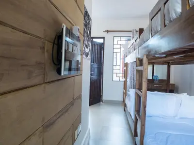 a bedroom with a bunk bed and a hallway at Mkomazi Hotels and Camps in Hegoma