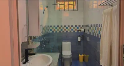 a bathroom with a toilet and a sink at Mkomazi Hotels and Camps in Hegoma