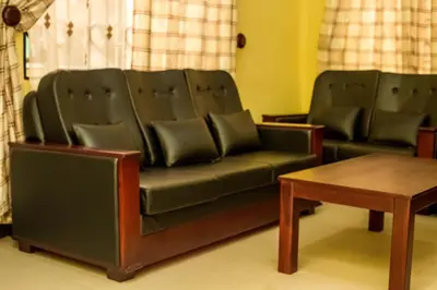 a living room with a couch and a table at Randa Family House - Moshi in Himo