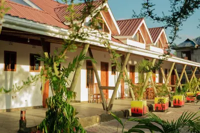 a courtyard of a building with chairs and plants at Heart of Africa Lodge in Arusha