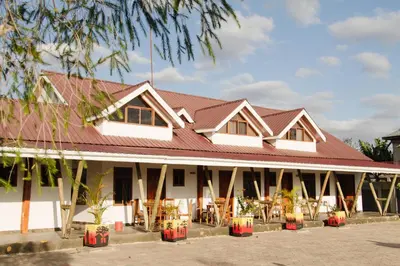 a large white building with a red roof at Heart of Africa Lodge in Arusha