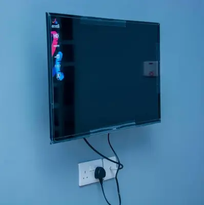 a flat screen tv hanging on a wall at Johnsons StopPoint in Zame