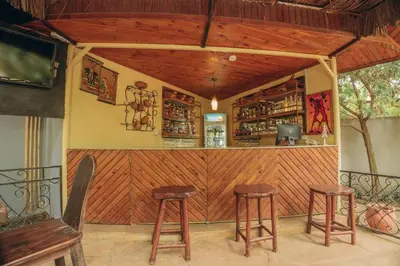 a bar with two stools in front of it at Villa Arumeru in Arusha