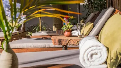 a table with a couch and a table with plants at Villa Arumeru in Arusha