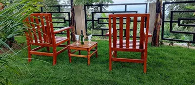 two chairs and a table with a bottle of wine at Materuni Homes in Moshi