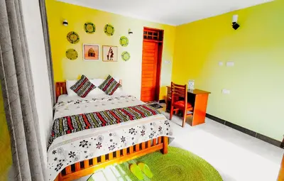 a bedroom with a bed and a desk in it at Materuni Homes in Moshi