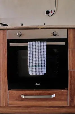 a microwave oven with a towel on the door at Hil Venture in Arusha