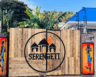 a wooden fence with a sign on it at Serengeti Villa in Arusha