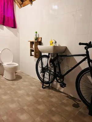 a bathroom with a bike parked next to a toilet at Serengeti Villa in Arusha
