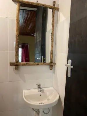a bathroom with a sink and a mirror at Serengeti Villa in Arusha