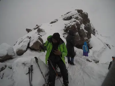 a person standing on top of a snow covered mountain at East Homestay in Boma la Ngombe