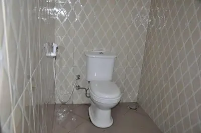 a bathroom with a white toilet in a room at B-MORE COMFORT STAY in Boma la Ngombe