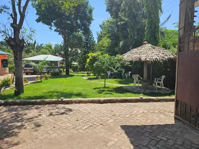 a garden with a gazebo and a table and chairs at B-MORE COMFORT STAY in Boma la Ngombe