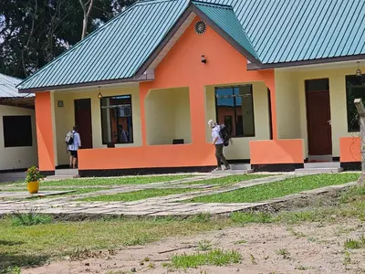 a person taking a picture of a building at B-MORE COMFORT STAY in Boma la Ngombe