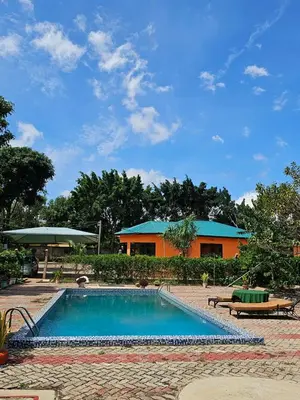 a swimming pool in front of a building at B-MORE COMFORT STAY in Boma la Ngombe