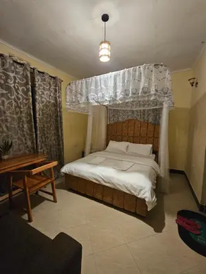 a bedroom with a bed with a canopy at B-MORE COMFORT STAY in Boma la Ngombe