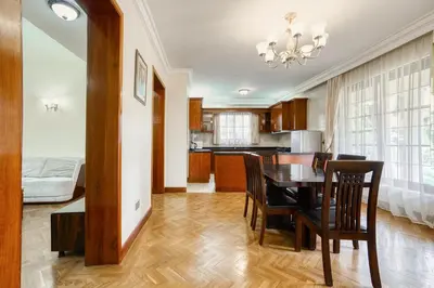 a kitchen and dining room with a table and chairs at Kibo Homes Moshi in Moshi