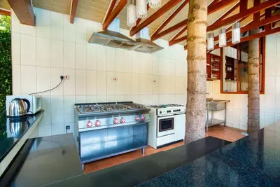 a kitchen with a stove and a counter top at Kibo Homes Moshi in Moshi