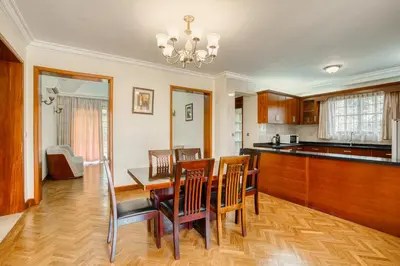 a kitchen and dining room with a table and chairs at Kibo Homes Moshi in Moshi