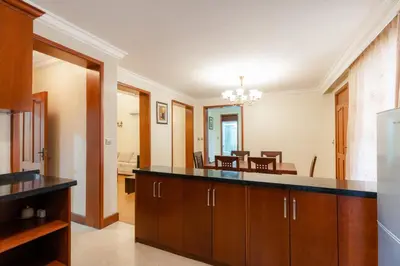 a kitchen with a counter and a dining room at Kibo Homes Moshi in Moshi