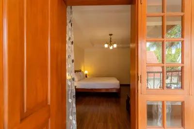 a door leading to a bedroom with a bed at Kibo Homes Moshi in Moshi