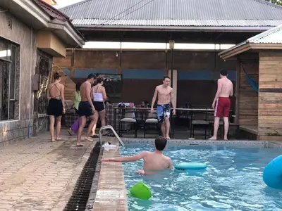 a group of people playing in a swimming pool at Arusha Safari Hostel in Arusha