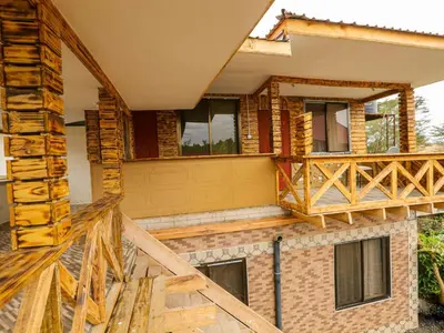 a house under construction with a wooden deck at Arusha Safari Hostel in Arusha