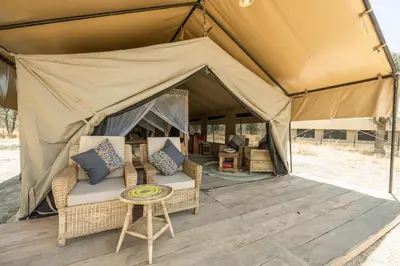 a tent with chairs and a table in front of it at Africa Safari South Serengeti Ndutu Ngorongoro in Sinoni