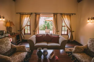 a living room with a couch and a table at The Manor at Ngorongoro in Karatu